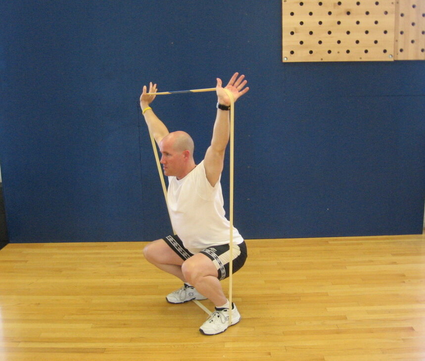 TAKU Doing an Over Head Squat with Woody Band