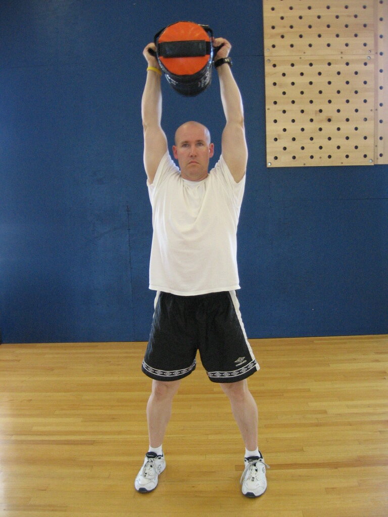 TAKU Doing a Sand-Bag shouldering press